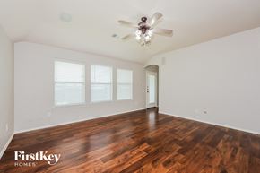 Fort Worth house for rent - A room with wooden floors and a ceiling fan.