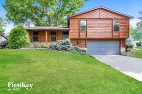 St Charles house for rent - a house with a lawn and a garage door