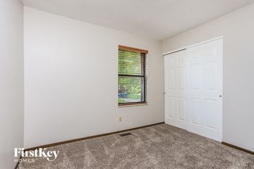 St Charles house for rent - the living room of a home with white walls and carpet and a window