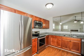 Cartersville house for rent - a kitchen with wooden cabinets and stainless steel appliances