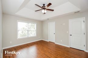 Cartersville house for rent - a living room with wood floors and a ceiling fan