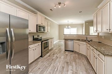 Concord house for rent - a kitchen with stainless steel appliances and white cabinets