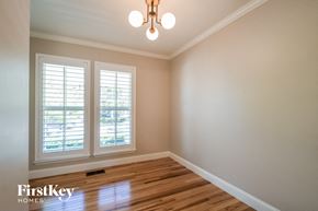 St Charles house for rent - a empty room with two windows and a wooden floor