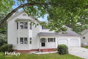Gainesville house for rent - a white house with a tree in front of it