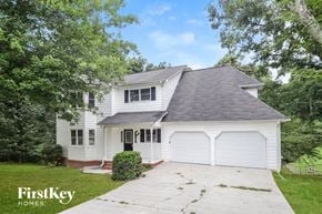Gainesville house for rent - a white house with a gray roof and a driveway