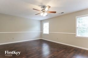 Gainesville house for rent - a living room with hardwood floors and a ceiling fan