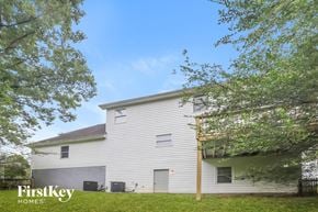 Gainesville house for rent - a white house with a yard and trees