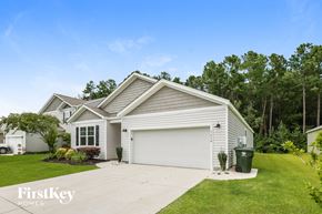 Moncks Corner house for rent - A house with a garage and a driveway in front of it.