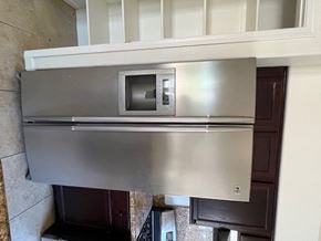 Glendale house for rent - a stainless steel refrigerator with a microwave on top of it