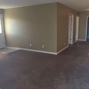 Clinton apartment for rent - an empty living room with a carpeted floor