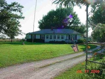 Clinton house for rent - a house with an flag on the side of a road