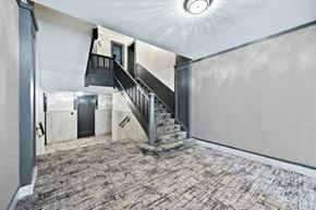 Chicago apartment for rent - the entryway of a house with a staircase and a ceiling light
