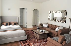 Chicago apartment for rent - A bedroom with a bed, a couch, and a mirror on the wall.