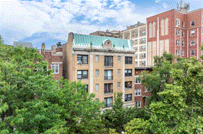 Chicago apartment for rent - A building with a green roof is surrounded by trees.