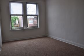 Chicago apartment for rent - an empty room with two windows in it