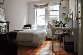 Chicago apartment for rent - a small bedroom with a bed and a window