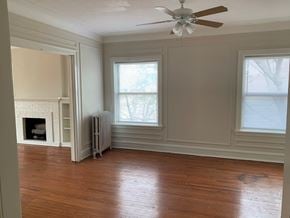 Evanston apartment for rent - a living room with wood floors and a ceiling fan