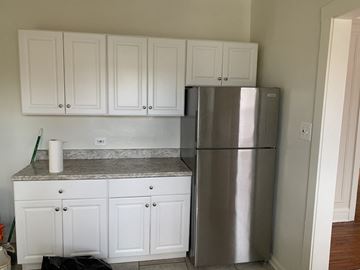 Evanston apartment for rent - a kitchen with white cabinets and a stainless steel refrigerator