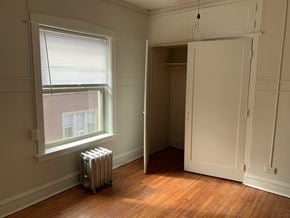Evanston apartment for rent - a room with a radiator and a window and a closet