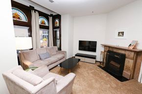 Chicago apartment for rent - a living room with a couch and a tv and a fireplace