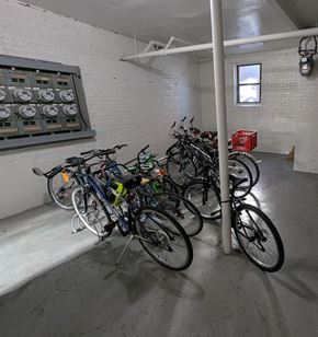 Chicago apartment for rent - A room with a white brick wall and a row of bicycles.