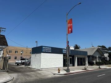 Long Beach apartment for rent - a building with a red flag on a street corner