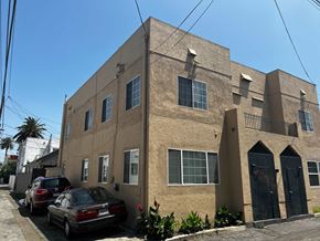 Long Beach apartment for rent - the exterior of a building with cars parked outside of it