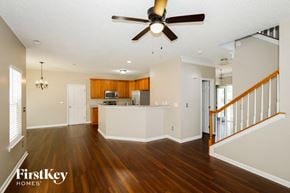 Indian Trail house for rent - A spacious living room with wood floors and a ceiling fan.