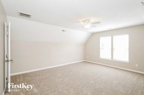 Indian Trail house for rent - A spacious room with a carpeted floor and a ceiling fan.