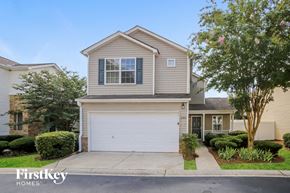 Woodstock house for rent - a beige house with a white garage door