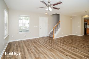 Woodstock house for rent - the living room with hardwood floors and a ceiling fan
