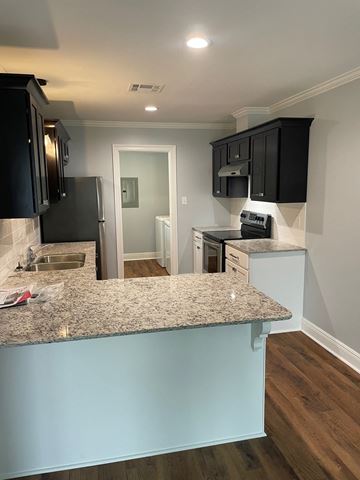 Eunice apartment for rent - a kitchen with granite counter tops and black cabinets