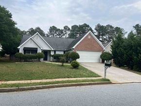 Lawrenceville house for rent - a house with a yard and a parking meter in front of it