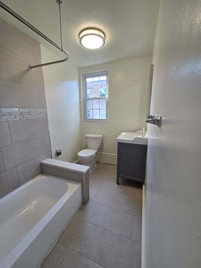 Ardmore apartment for rent - A white bathroom with a tub, toilet and sink.