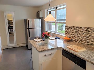 Bala Cynwyd apartment for rent - A kitchen with a refrigerator, a counter, and a window.