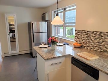 Bala Cynwyd apartment for rent - A kitchen with a refrigerator, a counter, and a window.
