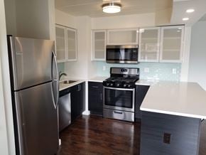 Ardmore apartment for rent - A kitchen with a refrigerator, microwave, oven, and stove.