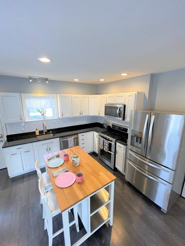Bala Cynwyd apartment for rent - A modern kitchen with a wooden table set for two.