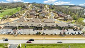 Bentonville apartment for rent - A suburban neighborhood with houses and cars parked in the driveways.