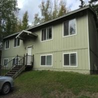 Wasilla apartment for rent - A house with a grey car parked in front.