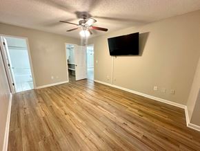 Clemson house for rent - A room with a ceiling fan and a flat screen TV mounted on the wall.