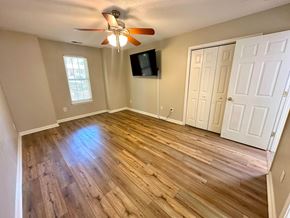 Clemson house for rent - A room with a ceiling fan and wooden flooring.