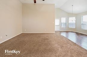 Katy house for rent - an empty living room with a carpeted floor
