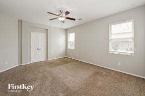 Katy house for rent - the master bedroom has a ceiling fan and carpeted flooring