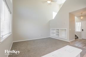 Brighton house for rent - an empty living room with a white wall and a window
