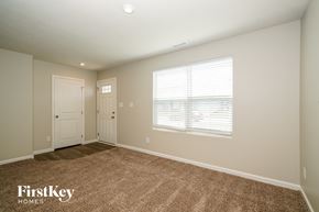 Greenwood house for rent - A room with two doors and a window with blinds.