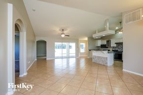 Cape Coral house for rent - A spacious kitchen and living room with a tiled floor and a ceiling fan.