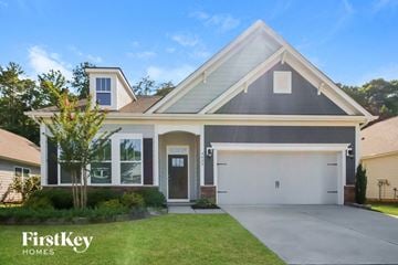 Denver house for rent - a gray house with a white garage door and a lawn