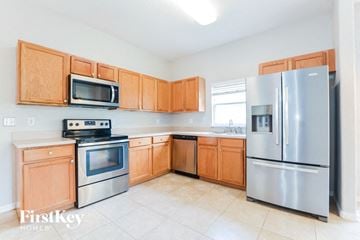 Lake Mary house for rent - a kitchen with stainless steel appliances and wooden cabinets