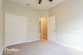 Lake Mary house for rent - a bedroom with two white doors and a ceiling fan